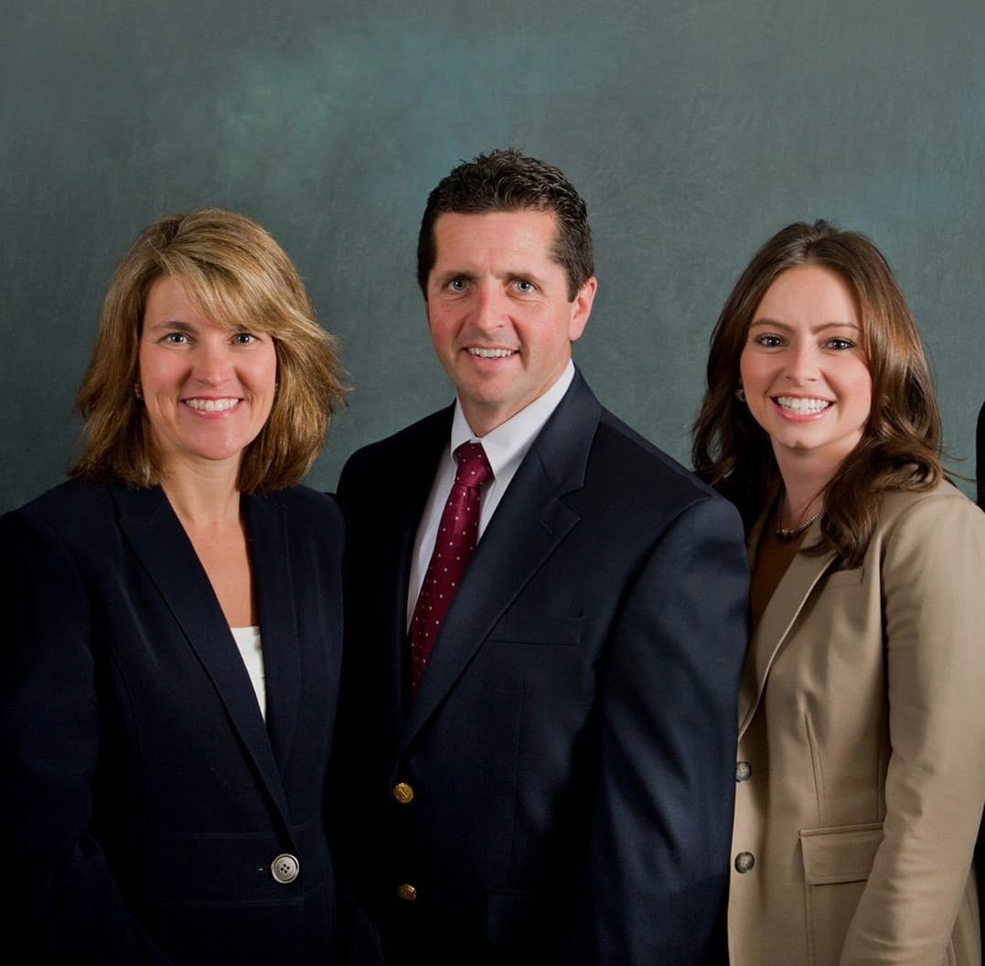 Professional team photo of three attorneys in business attire